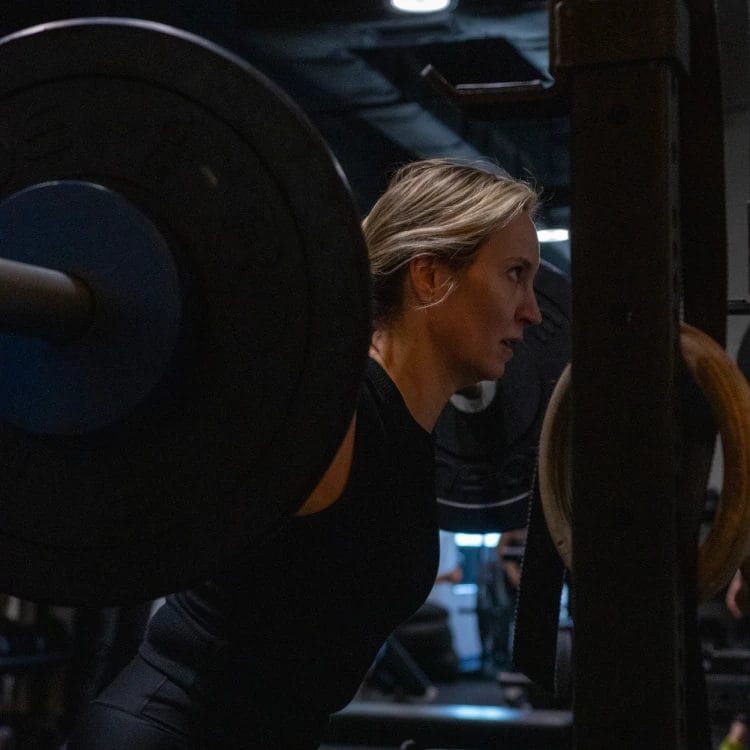 Woman lifting barbell at 8Well